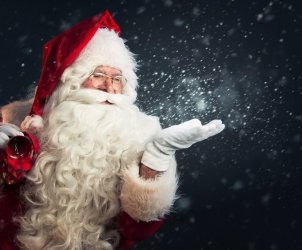 Santa Claus blowing magic snow of his hands